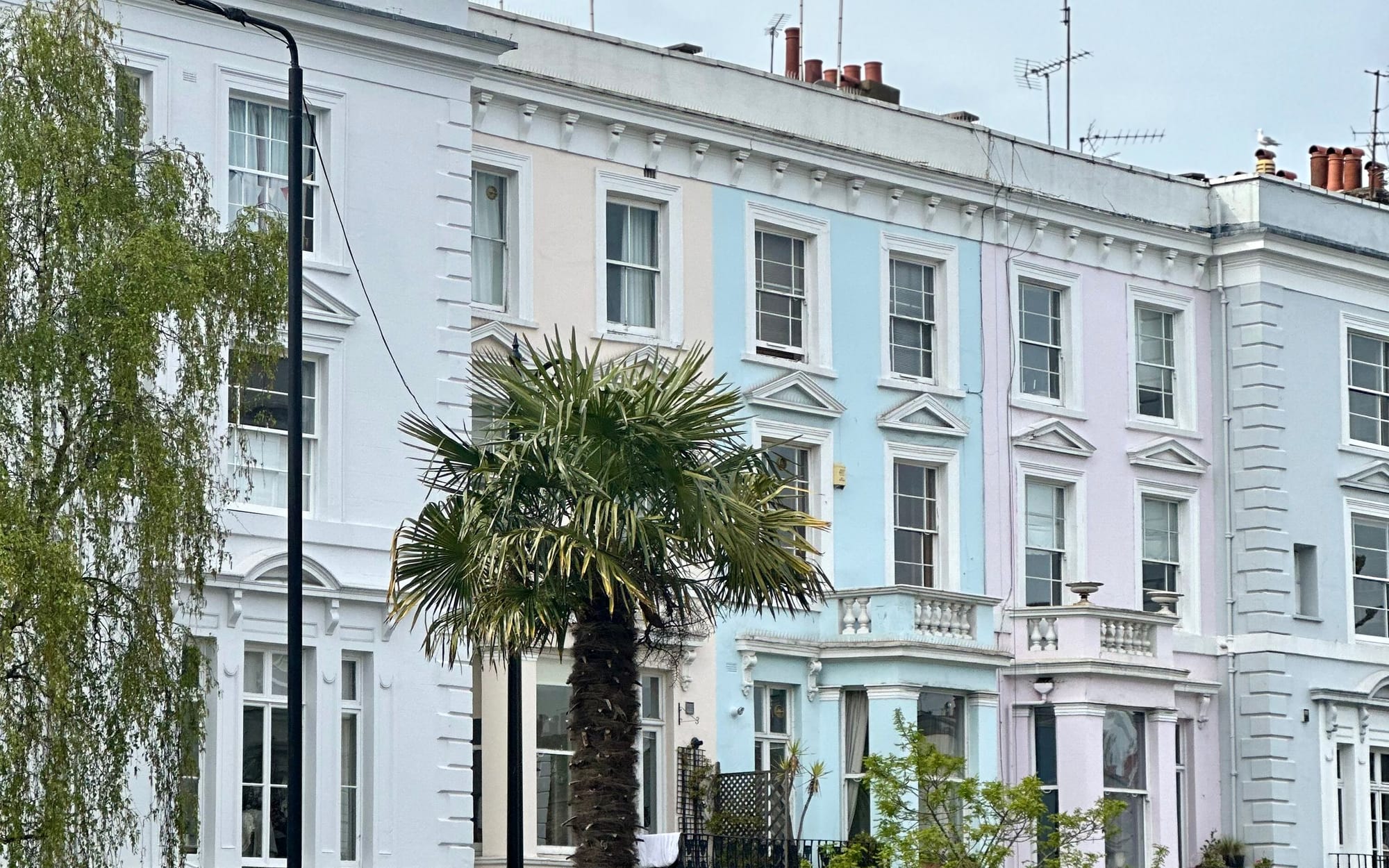 Pastel Notting Hill townhouses in afternoon light