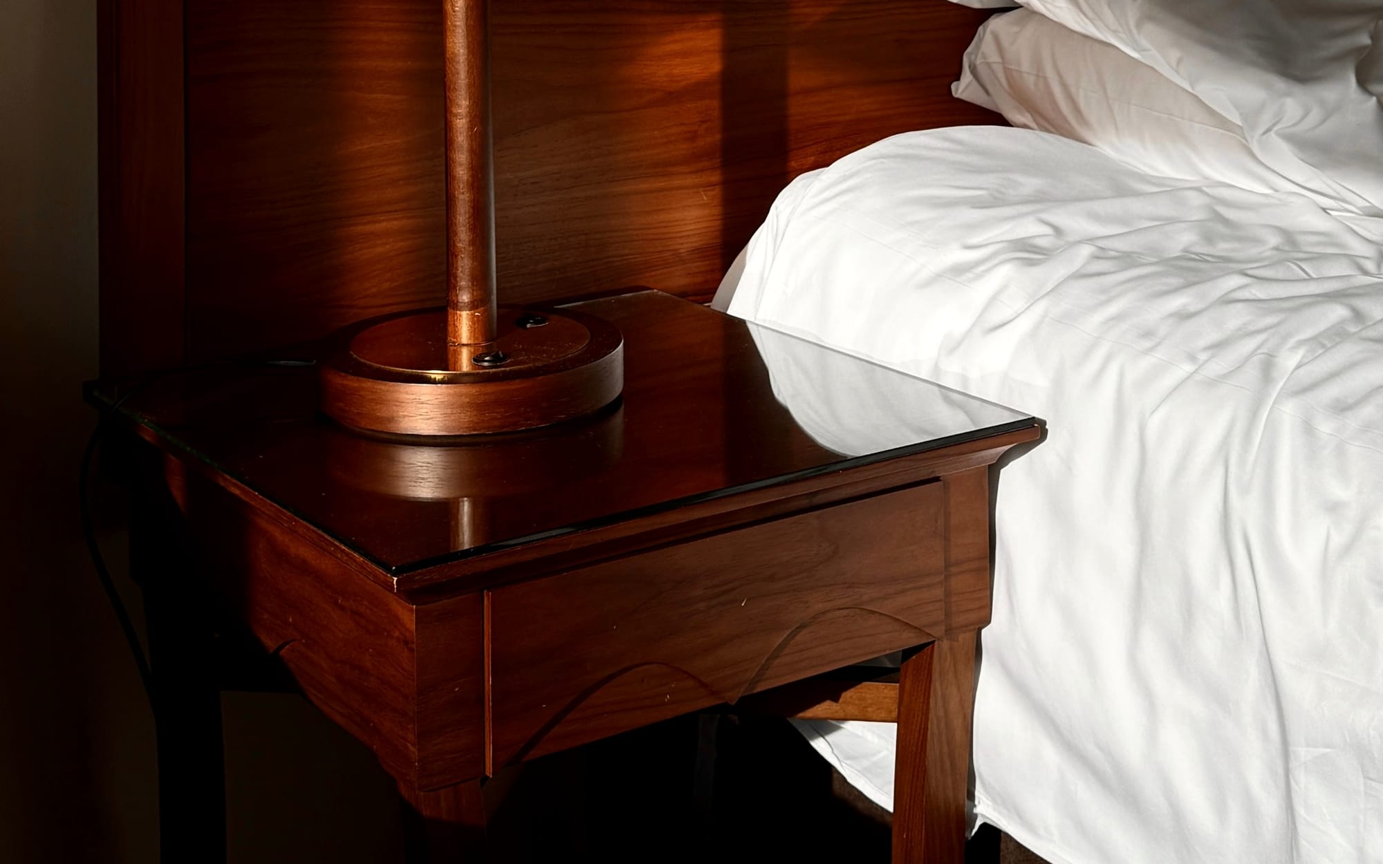 A quiet treatment room at dusk, curtains drawn, low lamplight