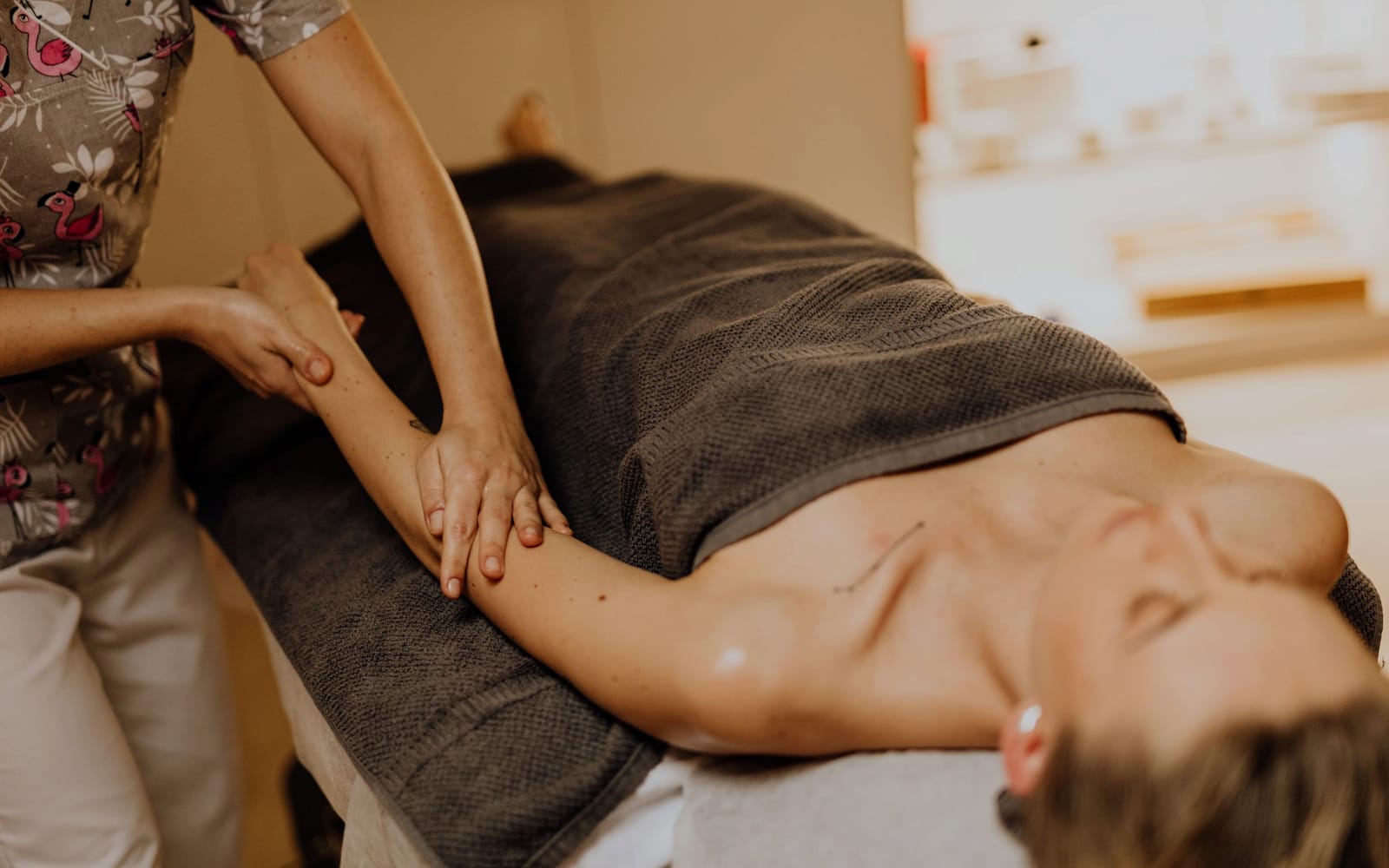 Oil being spread along a forearm with a smooth, even stroke