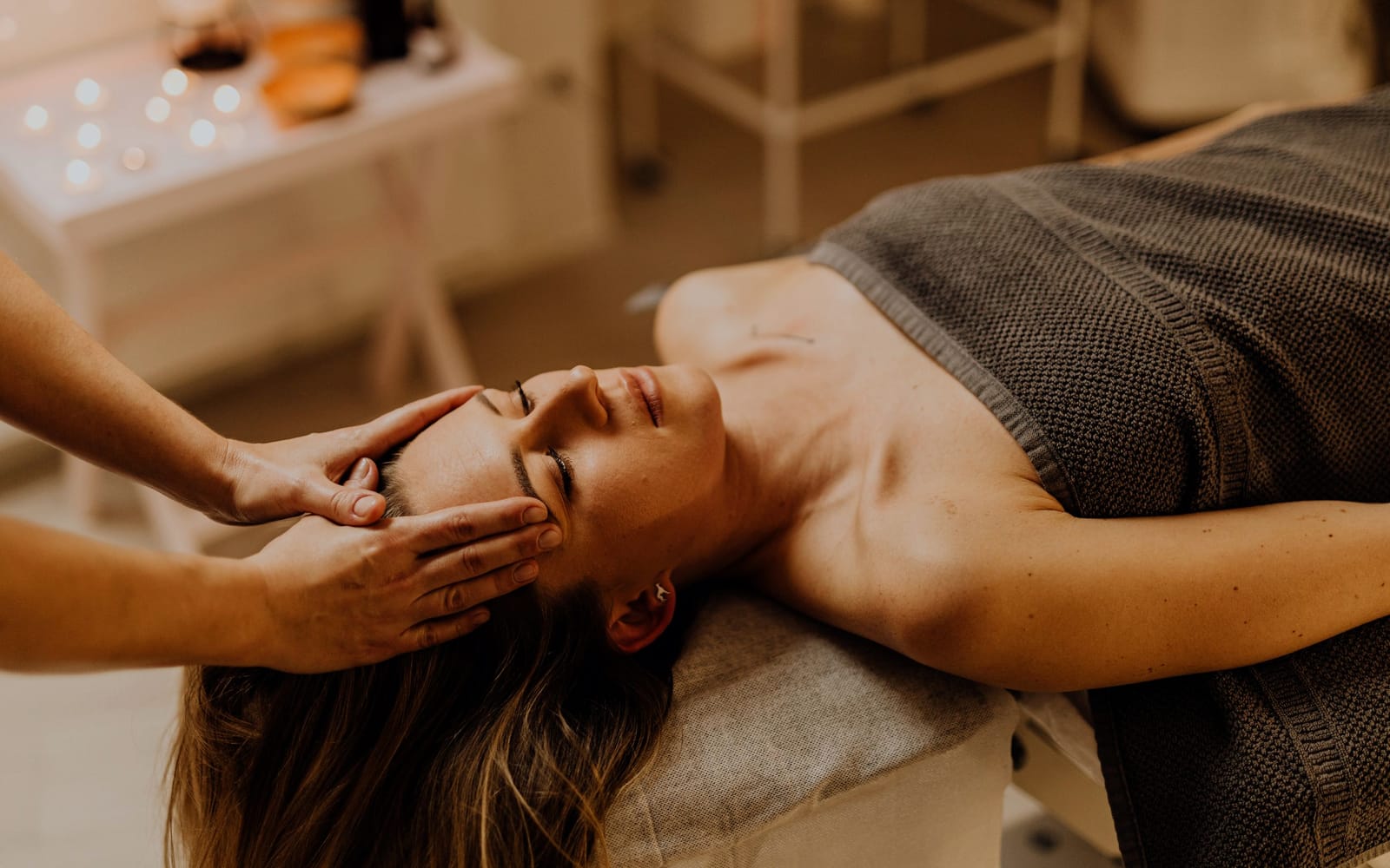 A long, flowing forearm stroke down the length of a client's back